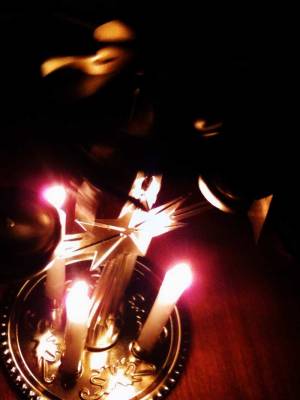 almost top view of fancy liturgical candles on a gold mount.